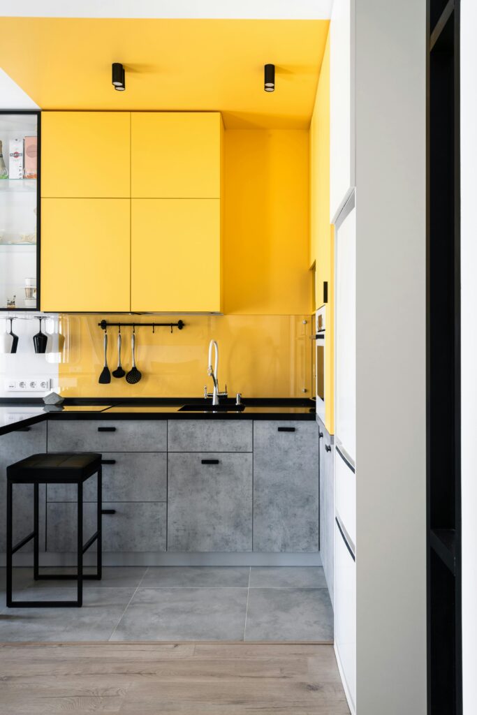 Bright yellow and gray kitchen with minimalist design in St. Petersburg.