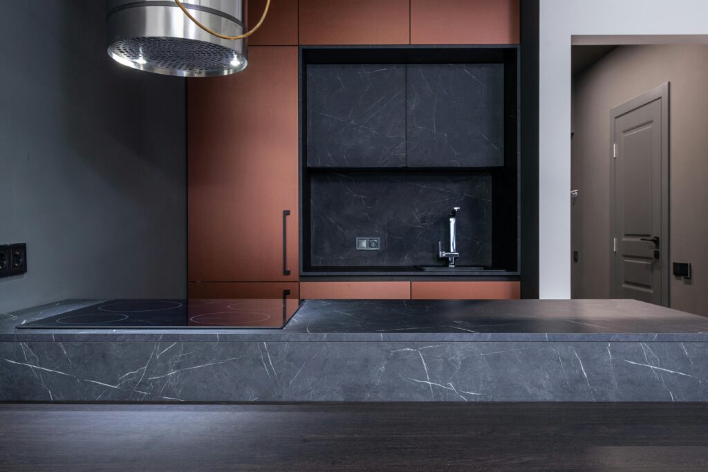 Elegant and modern kitchen with marble countertops and sleek design elements.