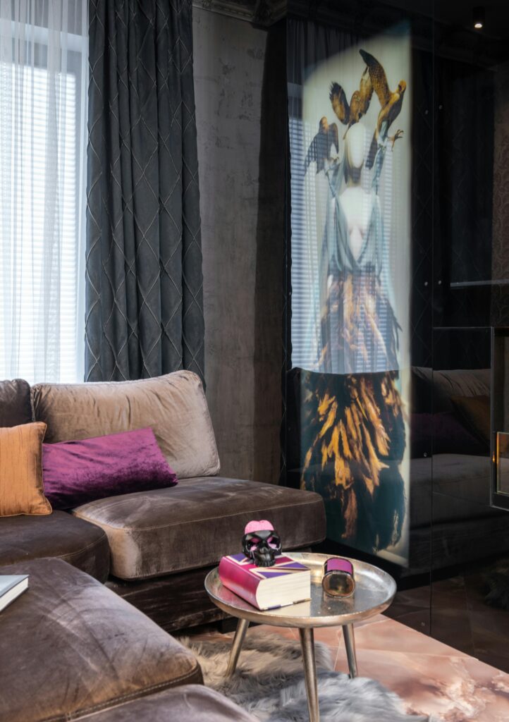 Stylish living room featuring a cozy sofa, modern decor, and artistic wall piece.