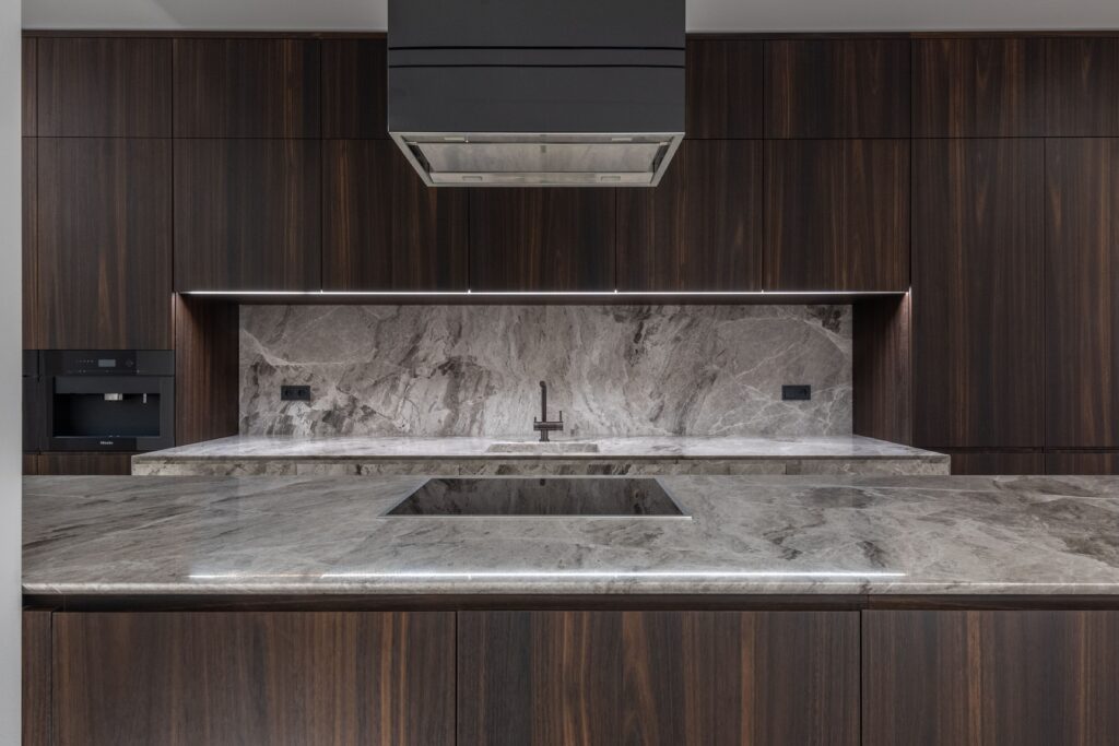 Interior of empty stylish kitchen interior in modern style with table and stove with air extraction