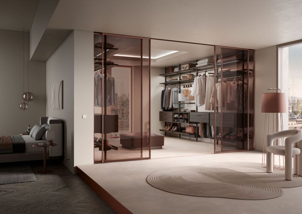 Elegant modern walk-in wardrobe with glass doors in a spacious bedroom setting, Distribuzione spazi interni casa.