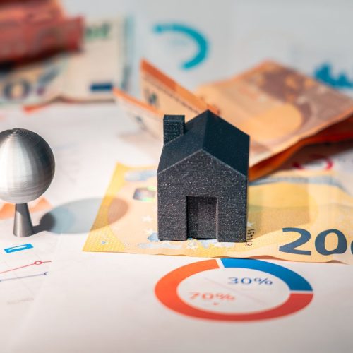 Conceptual image of real estate and finance involving euro currency and data charts, symbolizing investment, valorizzazione immobiliare.