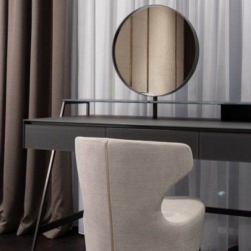 Comfortable soft chair and wooden table with round mirror near window covered with curtains in modern apartment, Stile contemporaneo chic